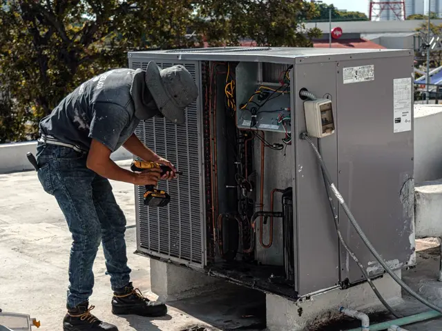 A technician servicing an air conditioner